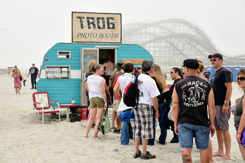 People lined up on the beach outside of The Little Detour Photo booth at The Race of Gentlemen in Wildwood New Jersy